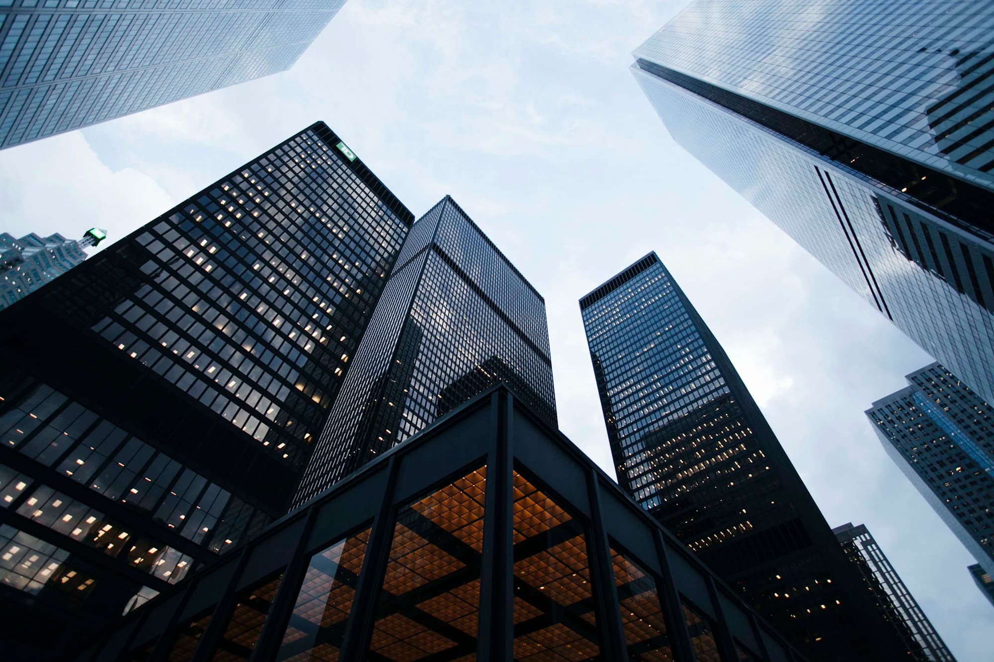 Office towers seen from street level against an overcast sky.