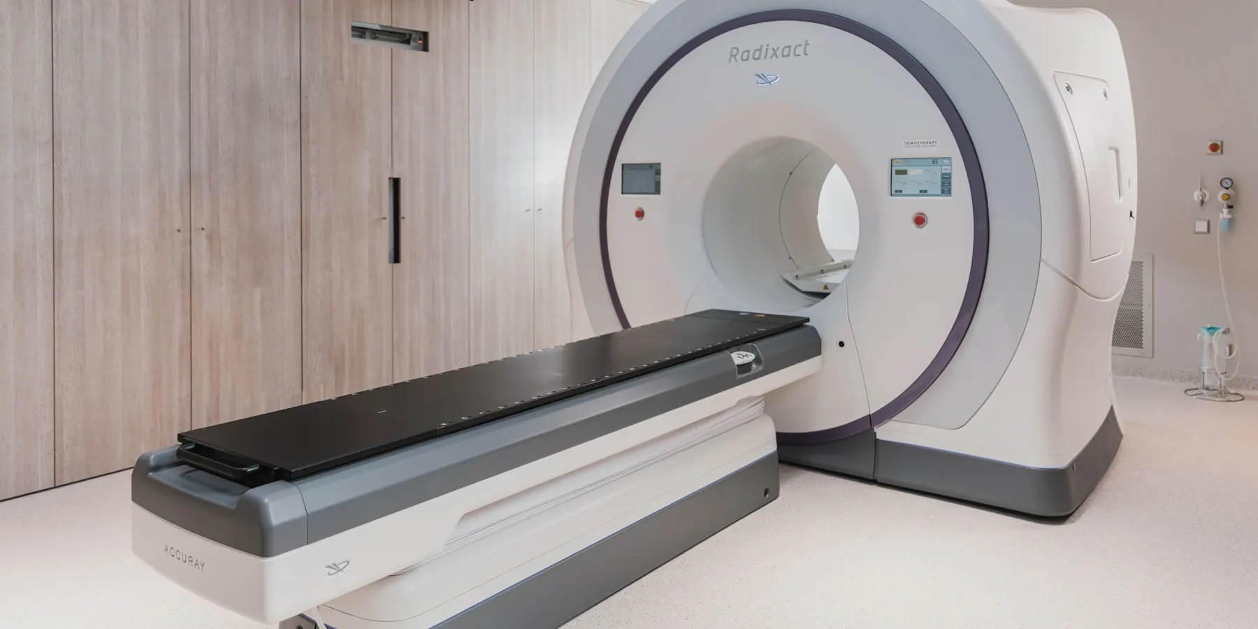 A scanner and its couch in a shielded examination room.